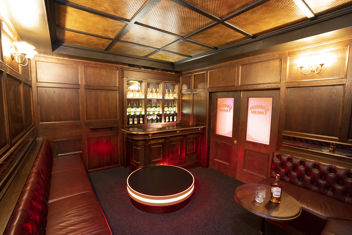 Private bar room with warm lighting and lounge seating